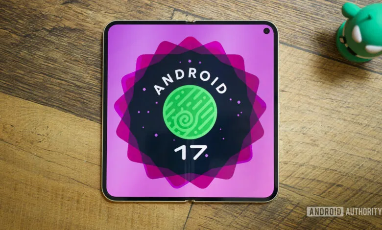 Foldable phone displays Android 17 logo on a wooden surface.