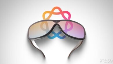 Apple Vision Pro glasses with colorful logo reflection on lenses.