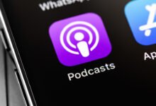 Close-up of iPhone screen showing the Podcasts app icon, a purple square with white concentric circles.