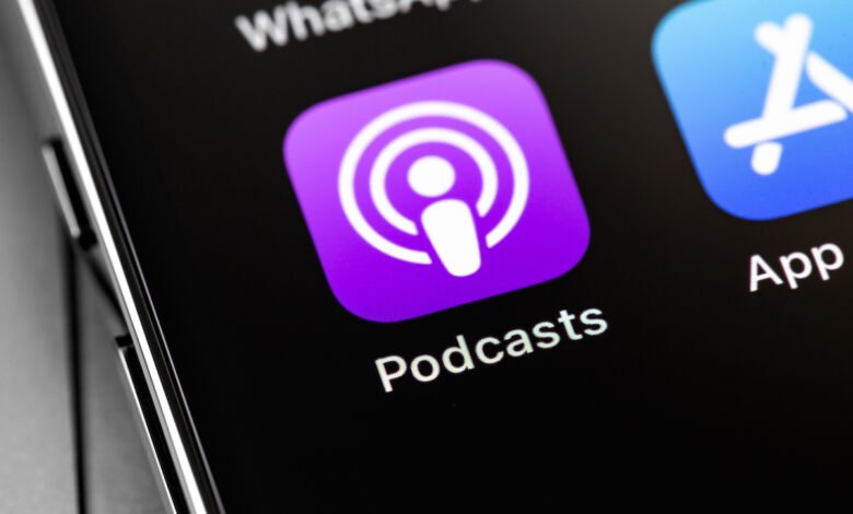 Close-up of iPhone screen showing the Podcasts app icon, a purple square with white concentric circles.
