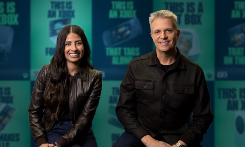Asha Sharma and Matt Booty pose in front of Xbox-themed backdrop.
