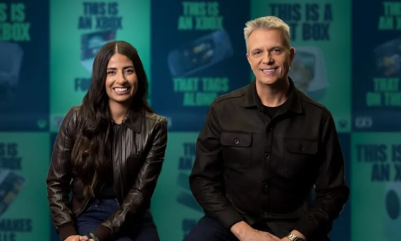 Asha Sharma and Matt Booty pose in front of Xbox-themed backdrop.