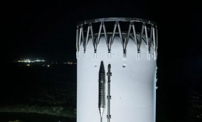 Starship prototype at night, showing its white exterior and metal framework.