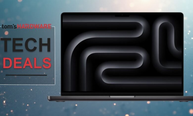 Laptop displaying 'Tech Deals' from Tom's Hardware on a blue background.