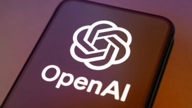 Smartphone displaying the OpenAI logo on a dark screen.