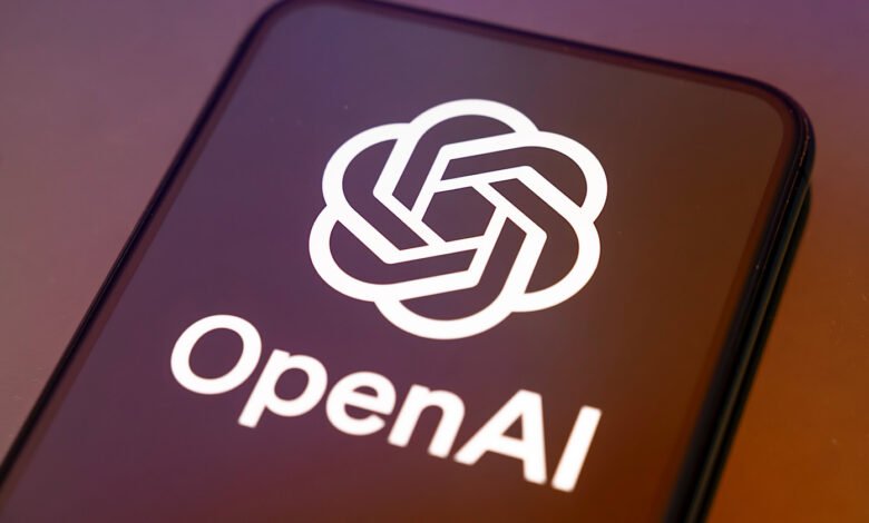 Smartphone displaying the OpenAI logo on a dark screen.