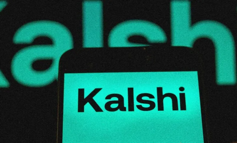 Close-up of a phone displaying the Kalshi logo in teal.
