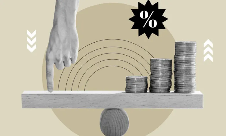 Hand balancing stacks of coins on a seesaw, illustrating financial balance.