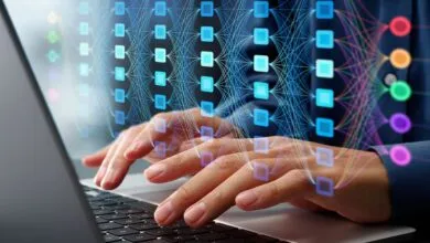 Hands typing on laptop with AI neural network visualization overlay.