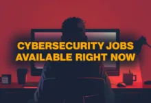 Person at computer with text overlay: Cybersecurity Jobs Available Right Now.