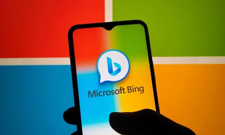 Smartphone displays Microsoft Bing logo against colorful Windows background.