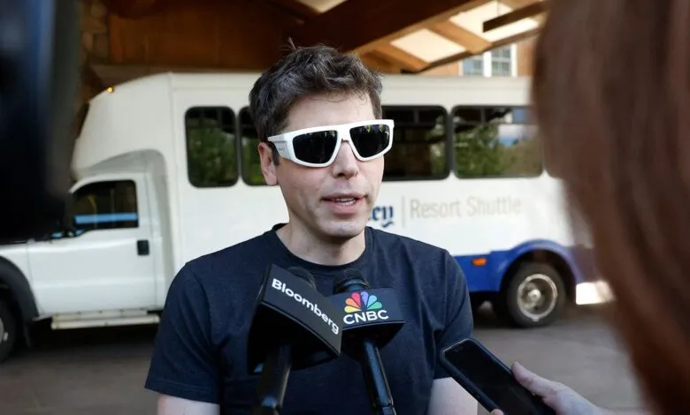 Sam Altman speaks to reporters wearing white-framed sunglasses.