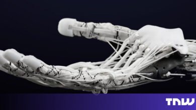 Close-up of a white robotic hand with visible strings.