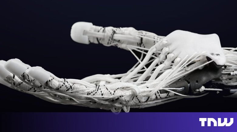 Close-up of a white robotic hand with visible strings.