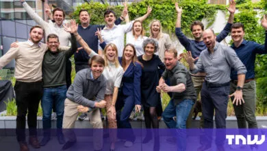 Enthusiastic group of diverse professionals celebrating outdoors.