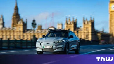 Gray Wayve autonomous vehicle driving in London with Big Ben in background.