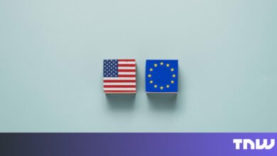 Two wooden blocks display the US and EU flags.