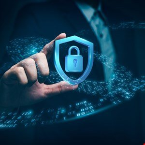 Hand holding a digital shield with a padlock, representing cybersecurity.