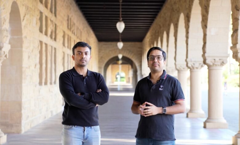 Two men stand in an arched corridor, posing for a portrait.