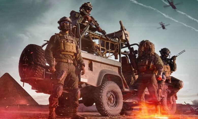 Four armed soldiers on a vehicle in desert with pyramids in background.