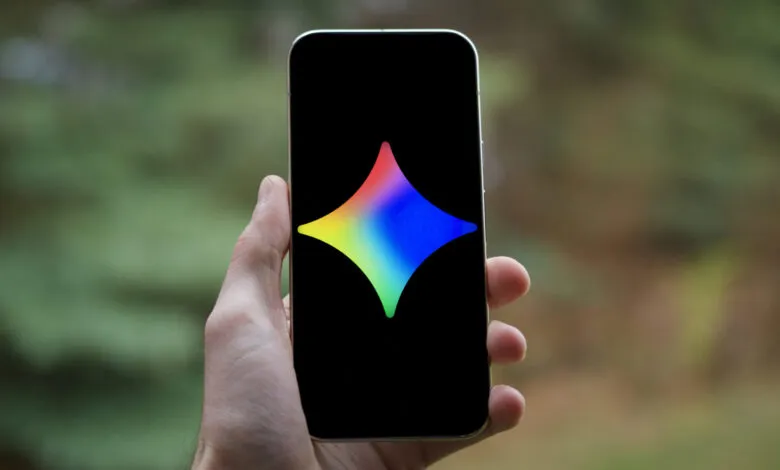Hand holding phone displaying a colorful star-shaped logo.