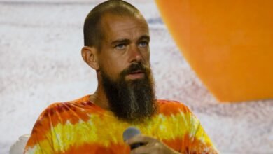 Jack Dorsey speaks into microphone, wearing tie-dye shirt.