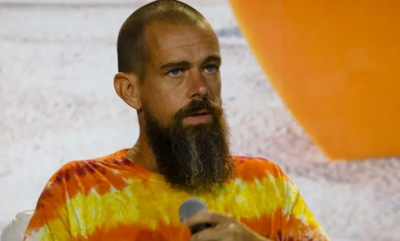 Jack Dorsey speaks into microphone, wearing tie-dye shirt.