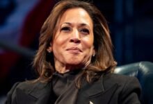 Close-up of Kamala Harris in a dark blazer, looking slightly upward.