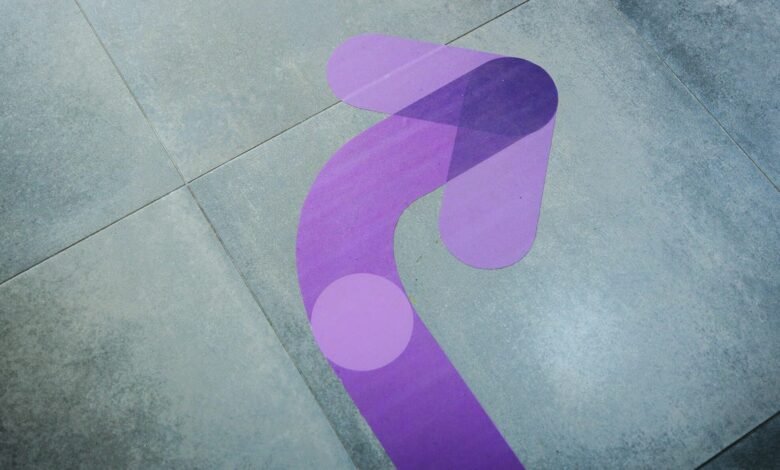 Purple arrow floor graphic on gray tile, pointing direction.