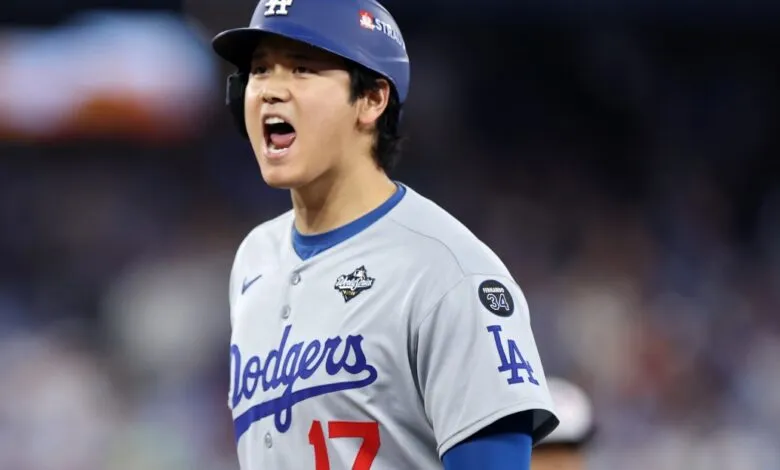 Shohei Ohtani yells wearing Dodgers jersey and helmet.