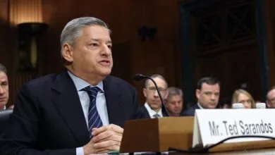 Ted Sarandos testifies at a hearing, speaking into a microphone.
