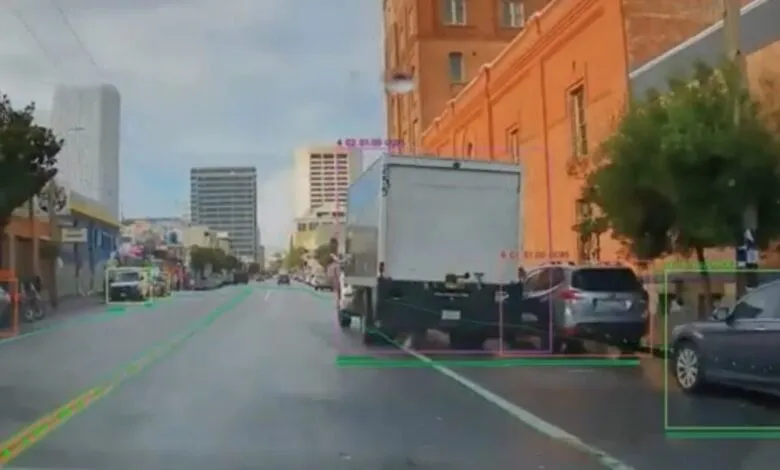 Self-driving car view of city street with object detection boxes.