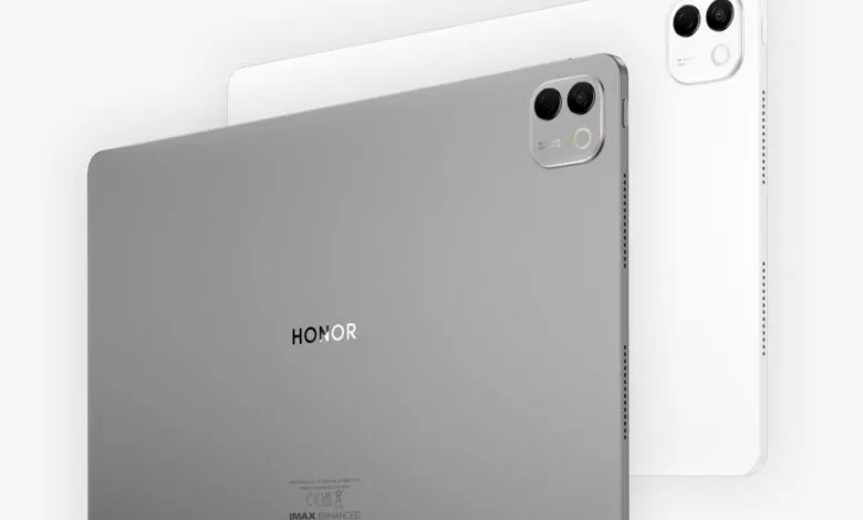 Two Honor MagicPad tablets, one gray and one white, angled on a white background.