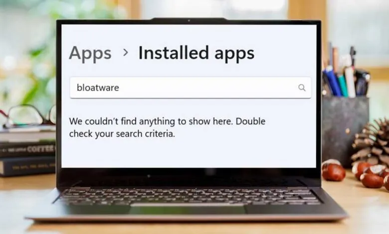 Laptop screen showing 'Apps > Installed apps' and a 'bloatware' search with no results.