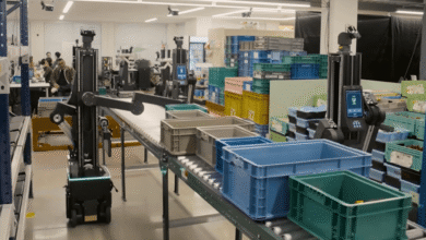 Automated robots sorting colorful bins in a modern warehouse setting.