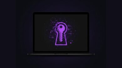 Laptop screen displays a keyhole with a key inside, pixelated and glowing purple.