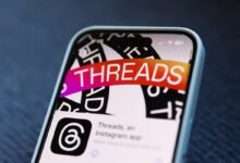 Close-up of a smartphone displaying the Threads app icon.