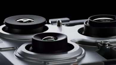 Close-up of three camera lenses on a silver device.