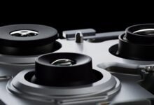 Close-up of three camera lenses on a silver device.