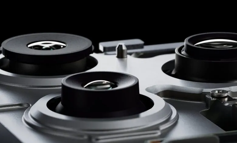 Close-up of three camera lenses on a silver device.