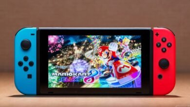 Nintendo Switch console showing Mario Kart 8 Deluxe game on its screen.