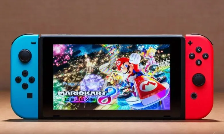 Nintendo Switch console showing Mario Kart 8 Deluxe game on its screen.