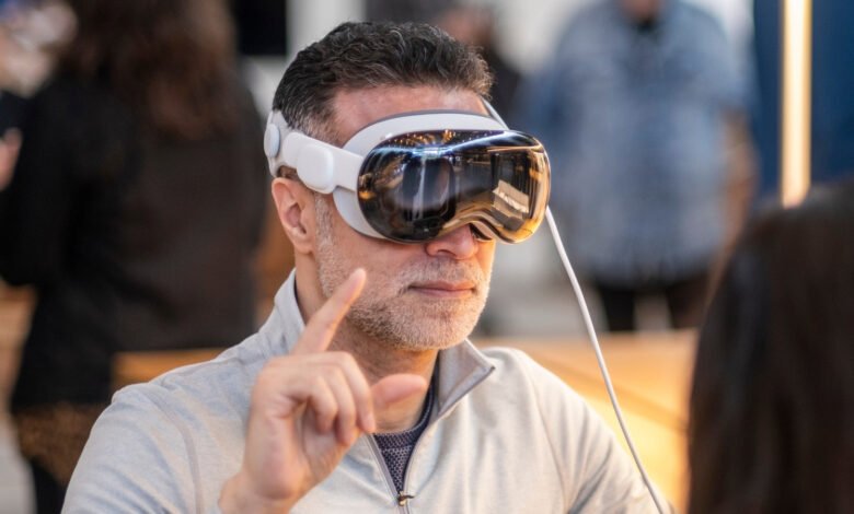 Man wearing white VR headset with reflective lenses, pointing upwards.