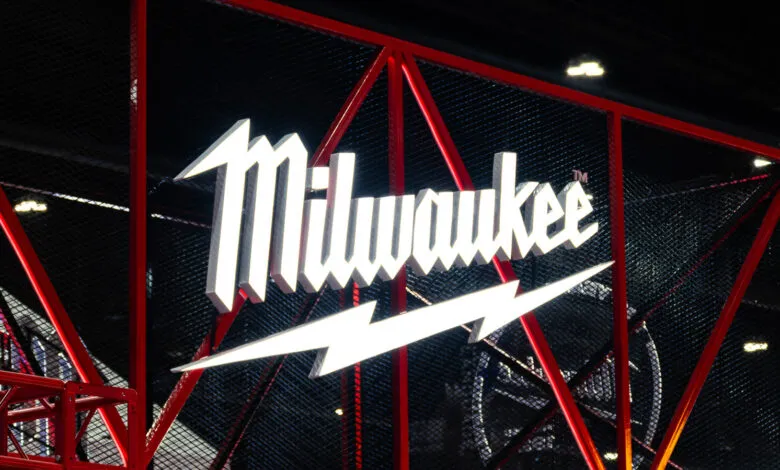 Milwaukee tool brand logo with lightning bolt on red metal frame.