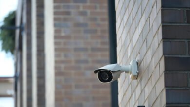 Security camera mounted on a brick building wall.