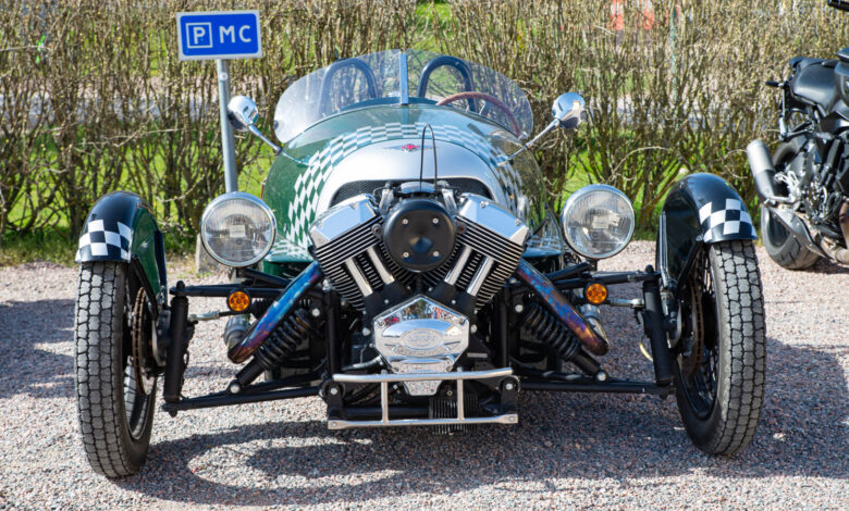 Front view of a green and silver Morgan 3 Wheeler car.