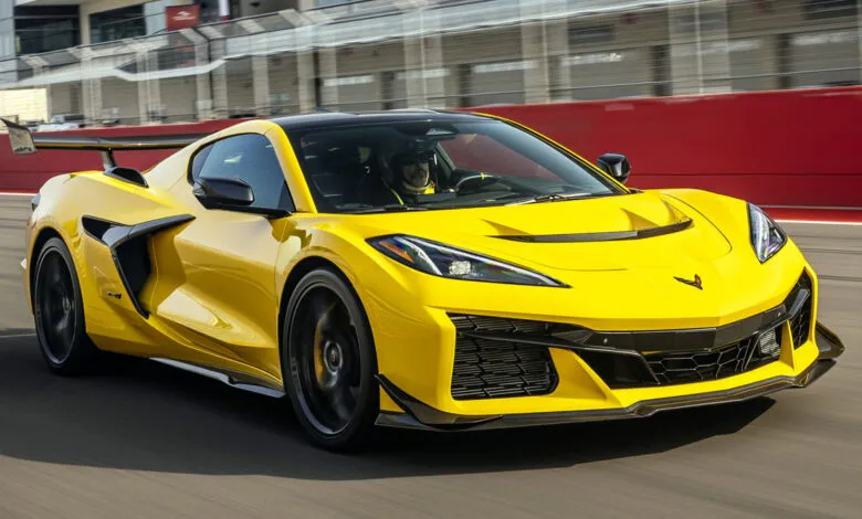 Bright yellow Corvette Z06 speeding on a racetrack with blurred background.