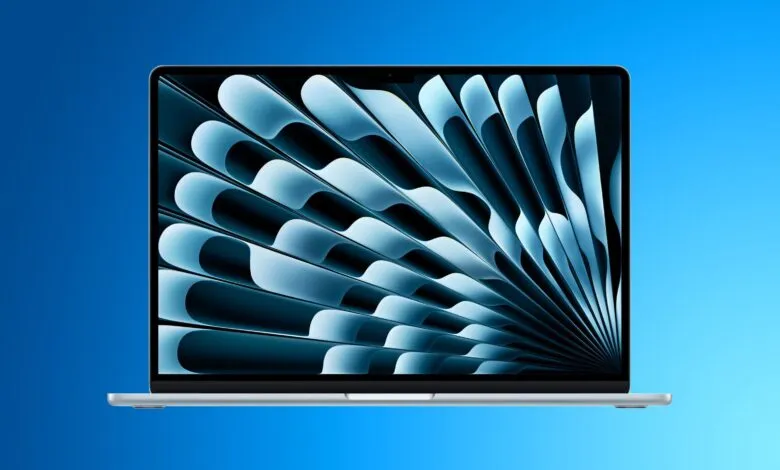 Silver MacBook Air laptop with a blue abstract wallpaper on the screen.