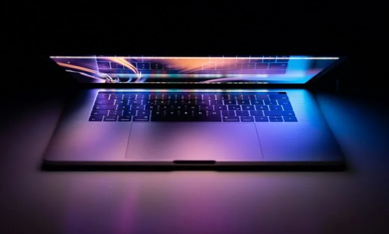 Illuminated laptop keyboard glows in the dark.