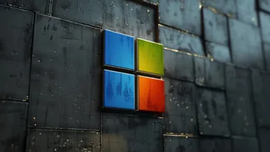 Microsoft logo on textured dark gray wall with blue, green, orange squares.